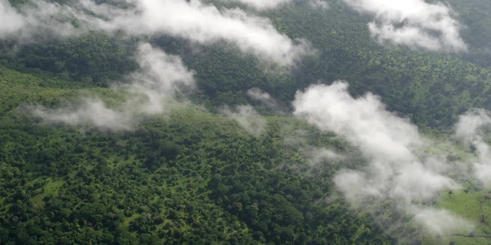 Aerial view above the clouds of a large hill range