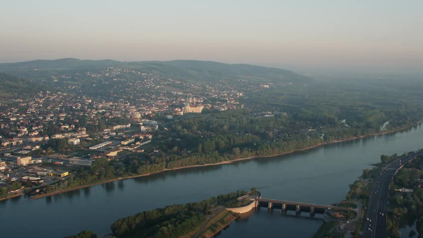 Aerial view of city along riverbank at dawn