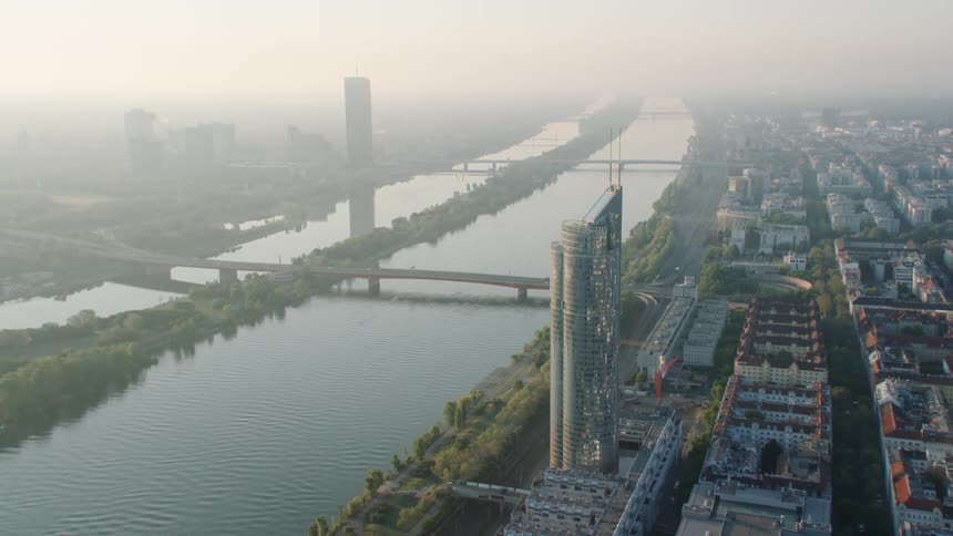 Aerial view of a foggy city next to the rivers