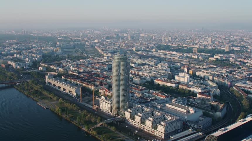 A waterfront skyscraper stands in a city