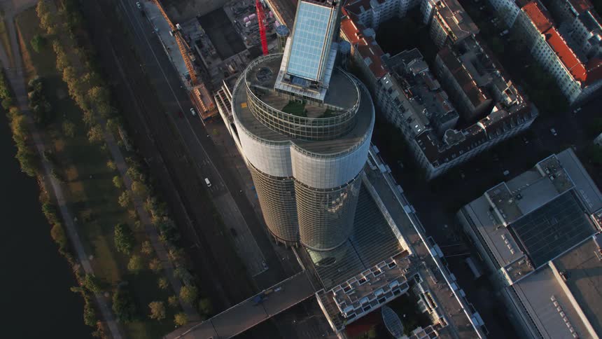 An aerial view of a tall skyscraper in a city