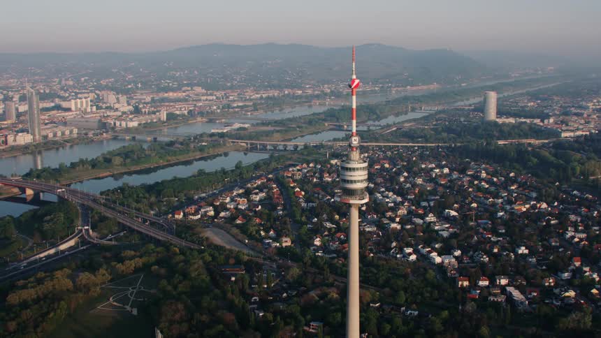 A tall tower sits before the set of homes in the city