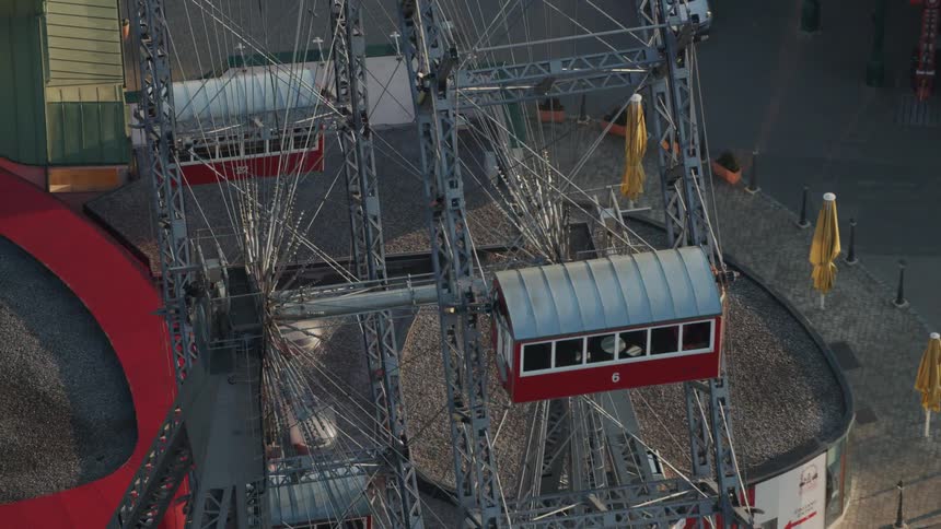 The vehicle drives past the empty ferris wheel