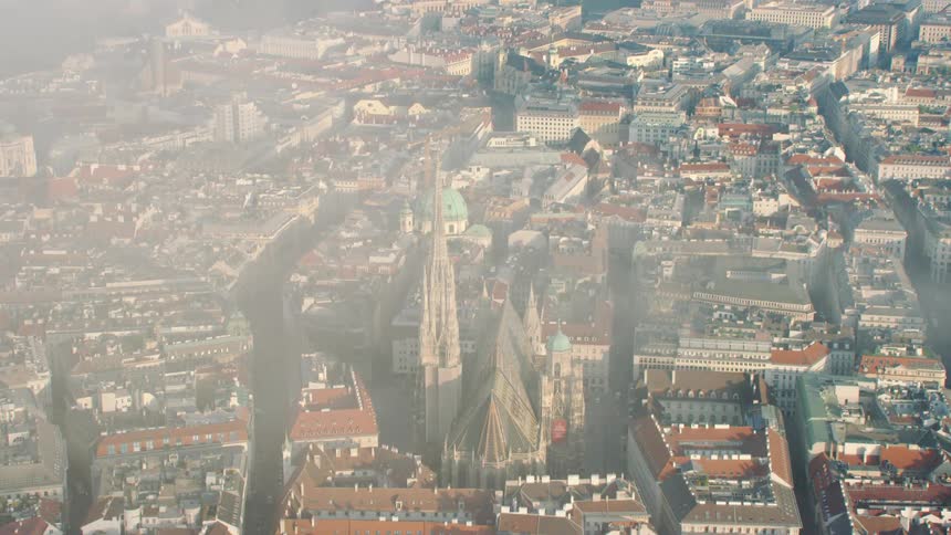 Fog drifts over elaborate cathedral inmiddle of sprawling city