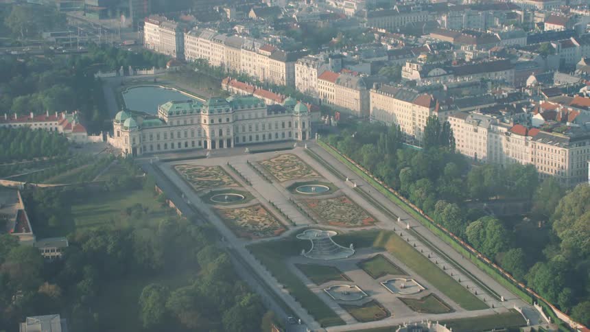 A large building with decorative landscaping in a city