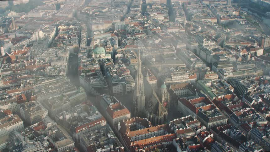 The tall tower sits between the buildings