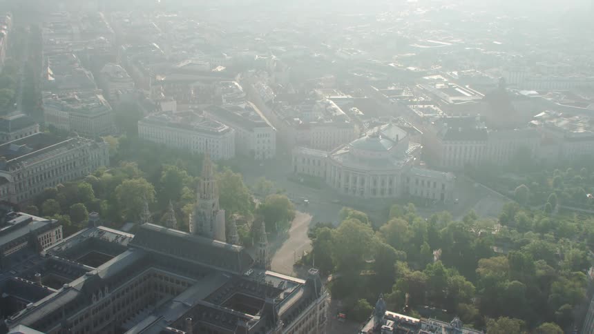 An aerial view of buildings in a city on a sunny day