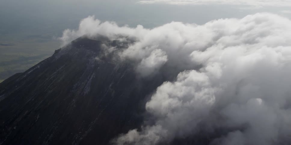 Aerial view of mountains with clouds on the surface
