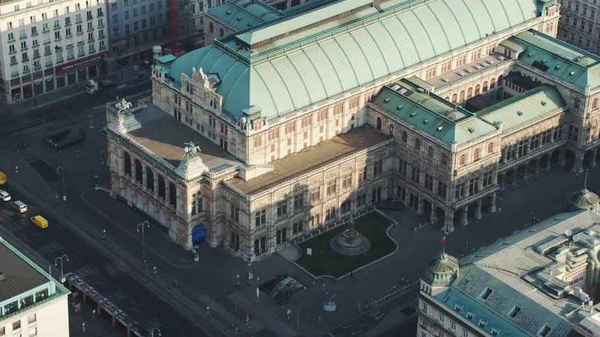 Cars and pedestrians go past a government building