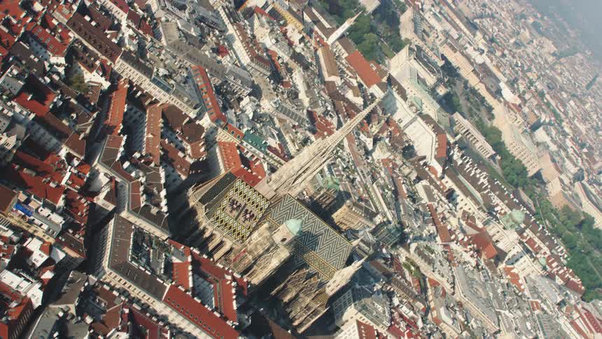 A cathedral in the middle of a city on a sunny day