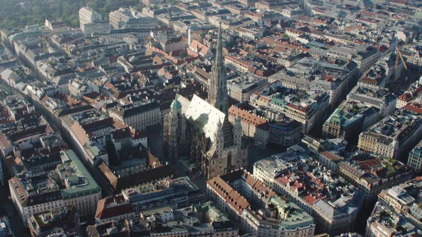 A cathedral in a tightly packed city during the day