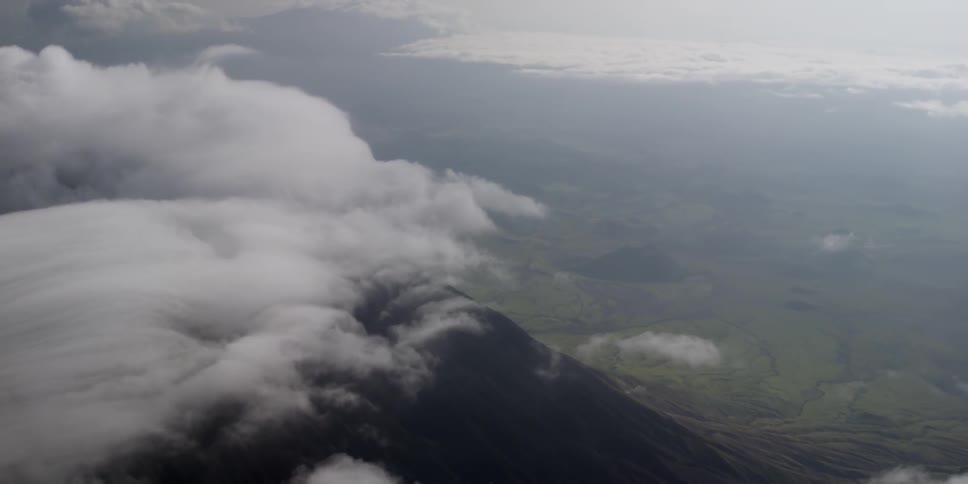 Aerial view above the clouds of a mountain