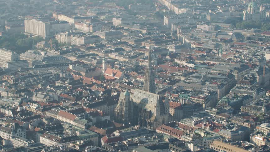 Aerial view of a city with large stone cathedral and buildings