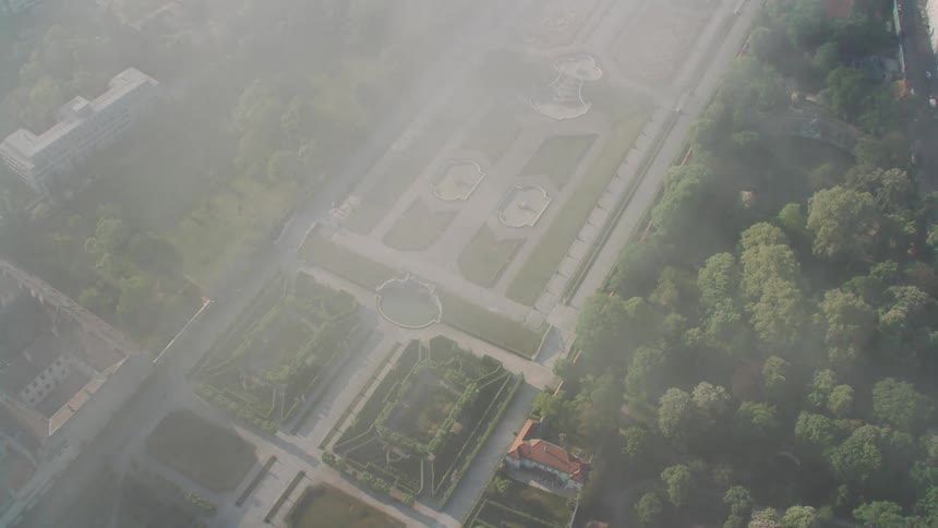 An aerial view of buildings and gardens in a city