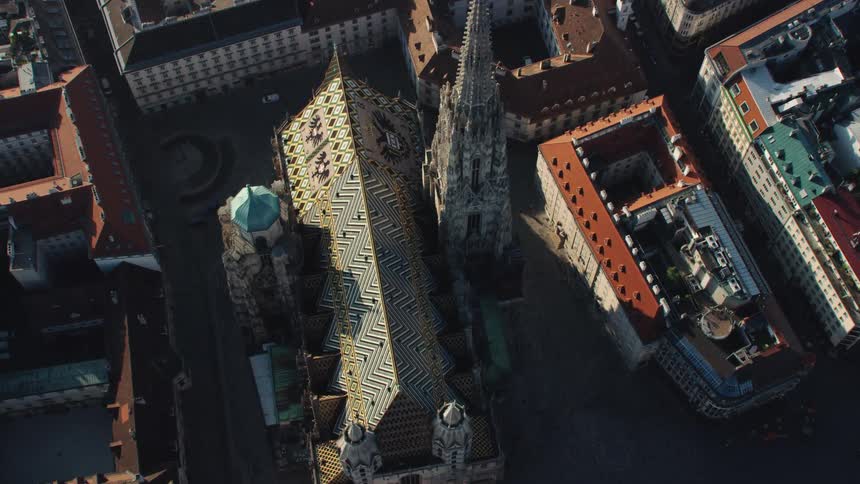 A large cathedral and the surrounding buildings in a dense european city