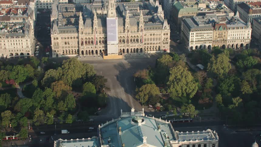 An aerial view of cars driving by buildings in a city