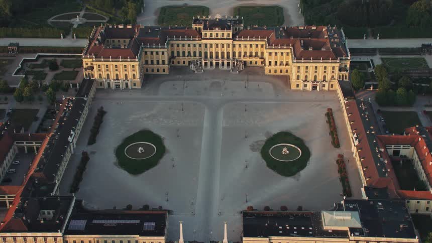 Twin water fountains in the courtyard of large elaborate building