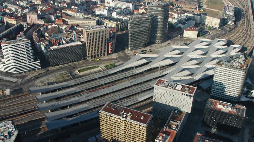 An aerial view of a train station surrounded by buildings in a city