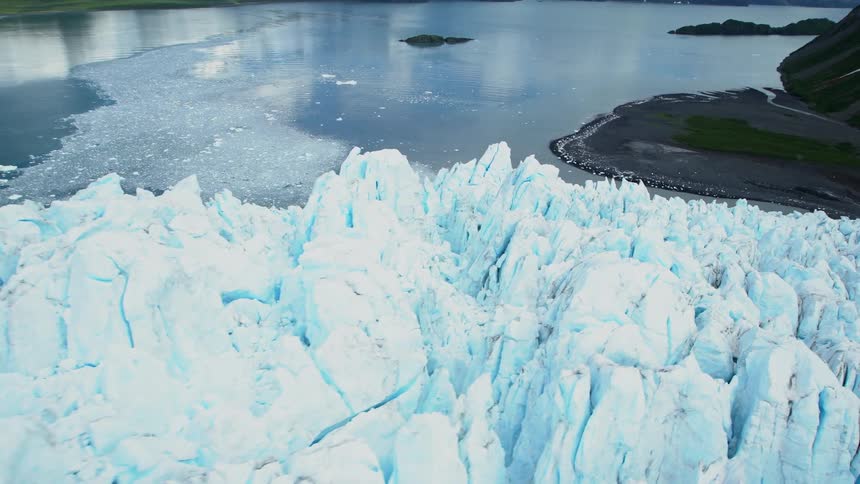 Glaciers near a lake with mountains in the background