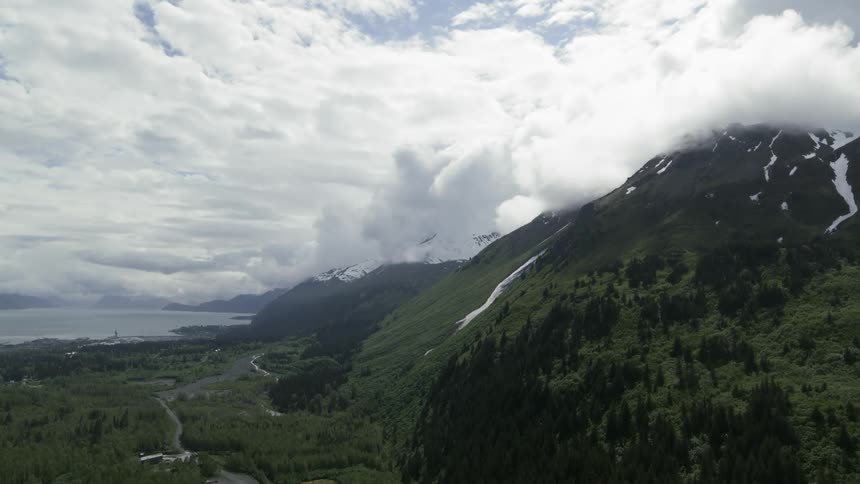 A mountain covered in vegetation on a cloudy day