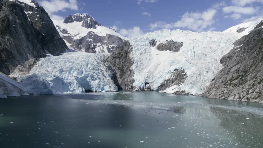 The water is frozen around the mountain
