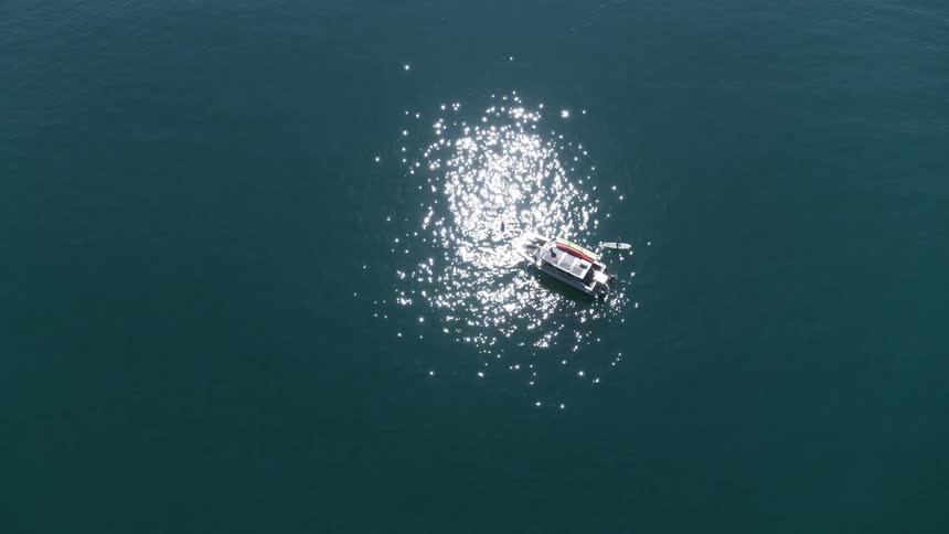 Boat and two sea kayaks on open ocean