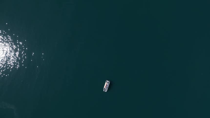 A boat is sailing in the blue waters below
