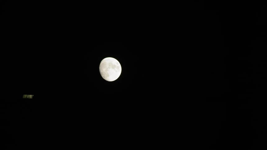 A spacecraft is moving in front of the moon in the universe