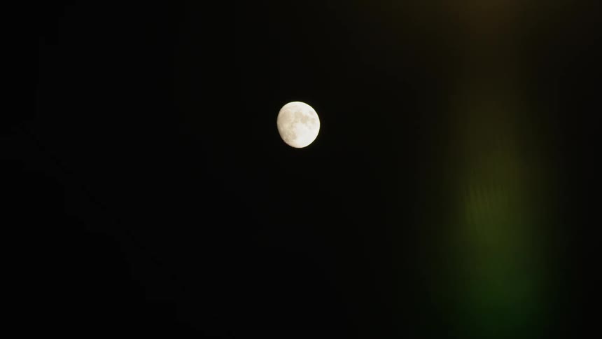 The moon sits in the sky