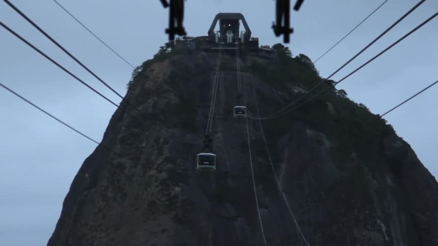 Elevators are passing over a gap in two mountains on wires