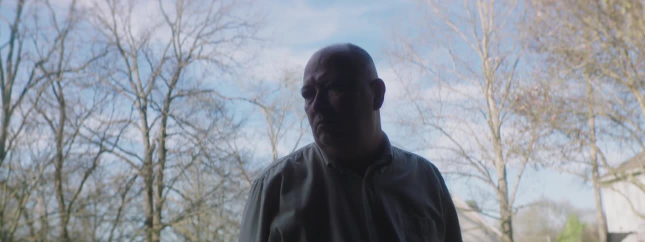 A man opens up a doorway and walks in