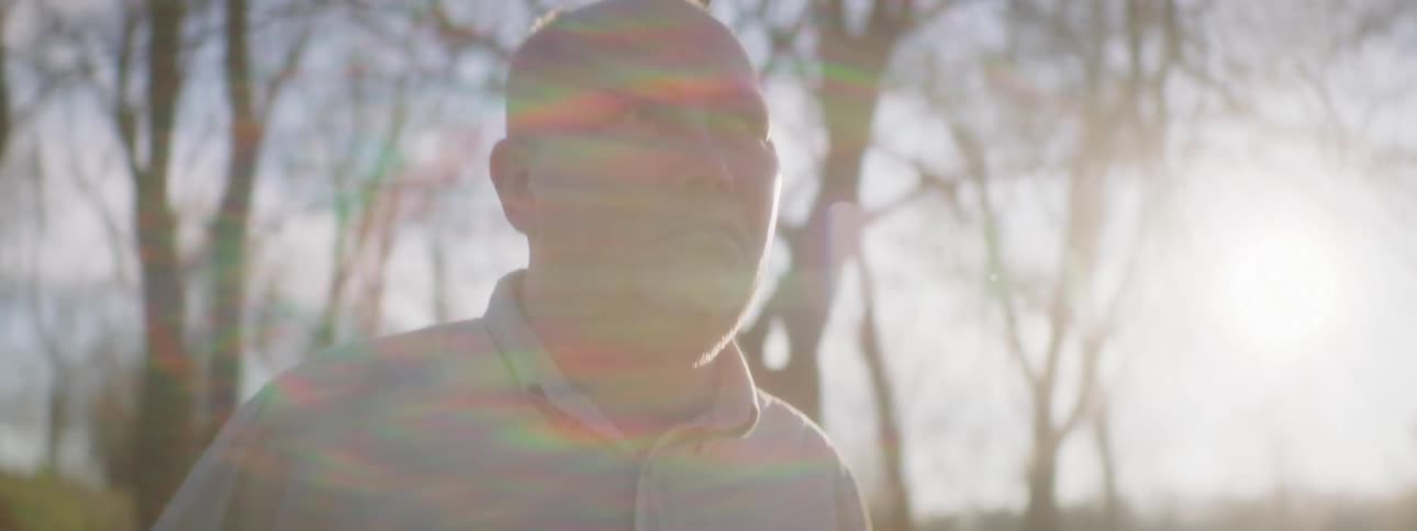 Man anxiously looks around in the countryside