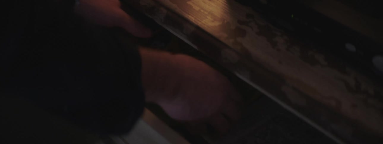 A person is grabbing pencils out of a drawer