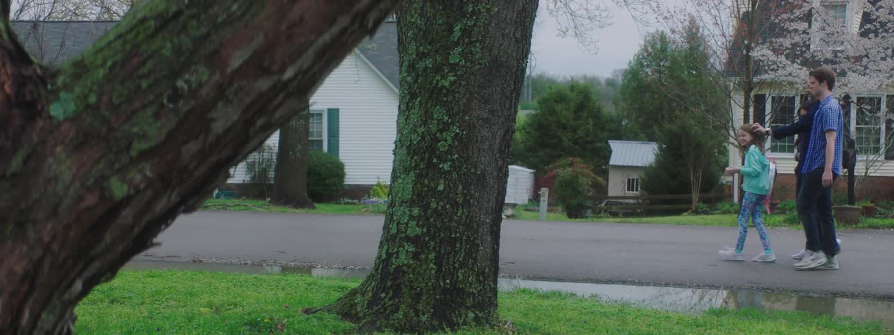 Family walks down the street in the neighborhood