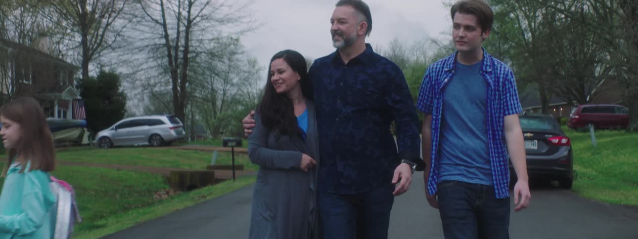 Family walks down the street in the neighborhood