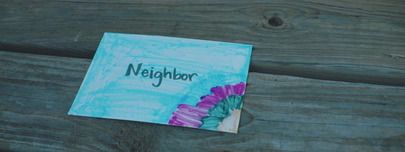 Handwritten card decorated with the word neighbor on it