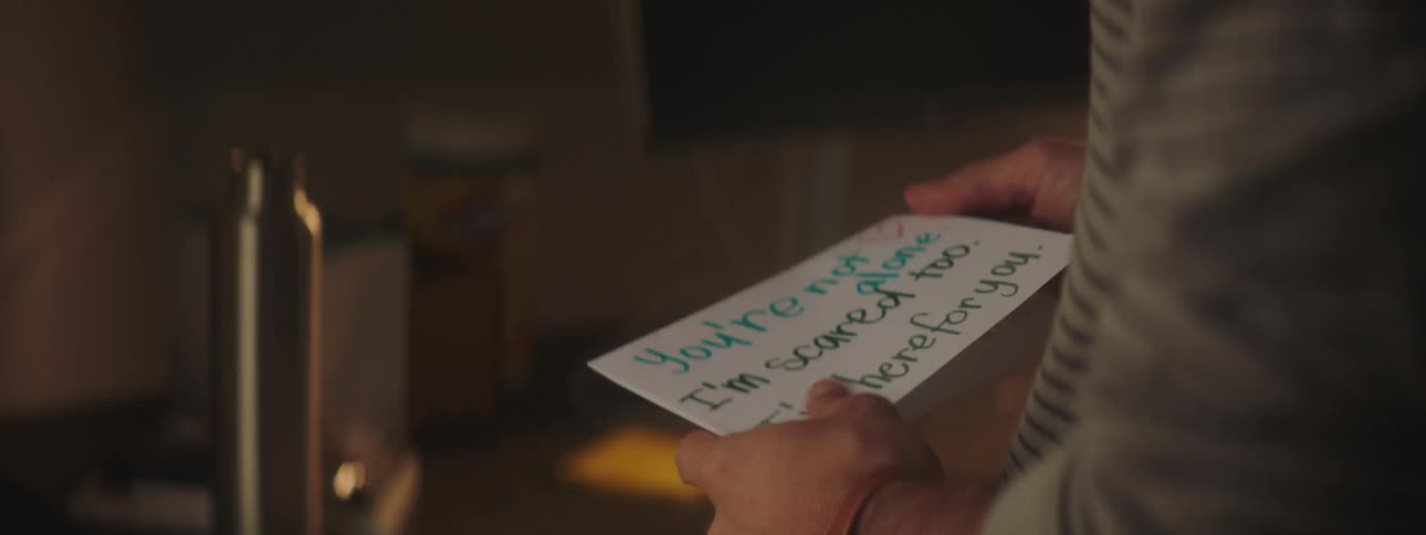 A person opens and reads a handwritten card