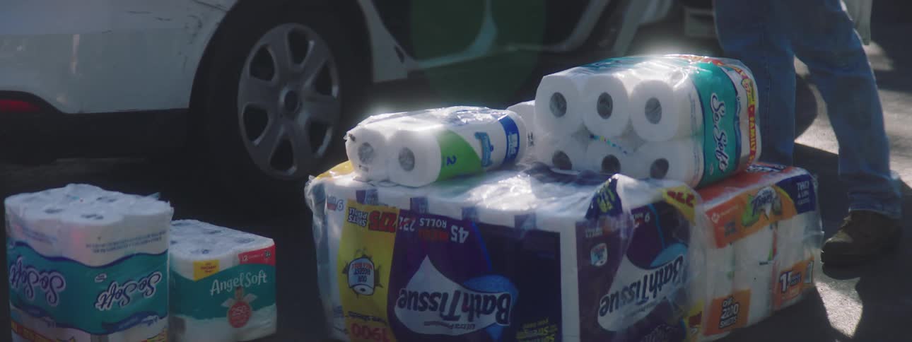 A man unloads paper products out of his car