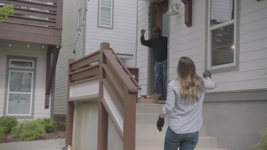 Woman leaves food bags on the doorstep