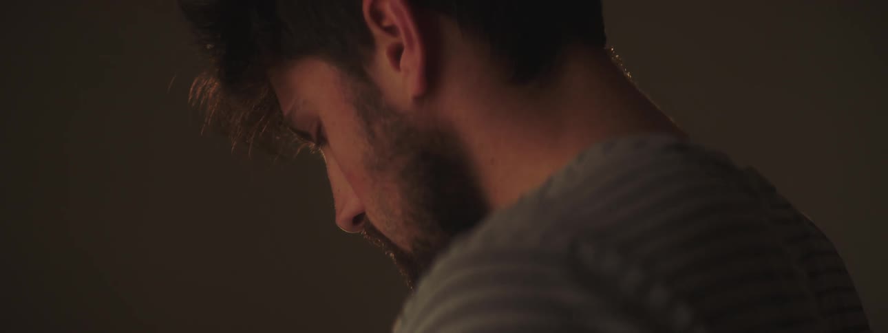 Bearded man uses smartphone indoors