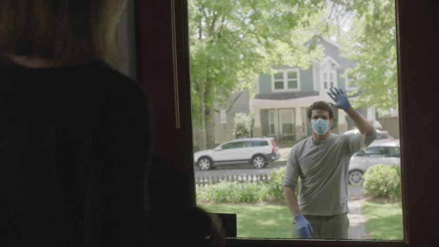 A teenager delivers items to a woman and they wave to one another