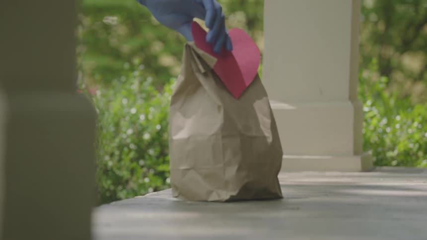 A person delivers a bag with a heart on it