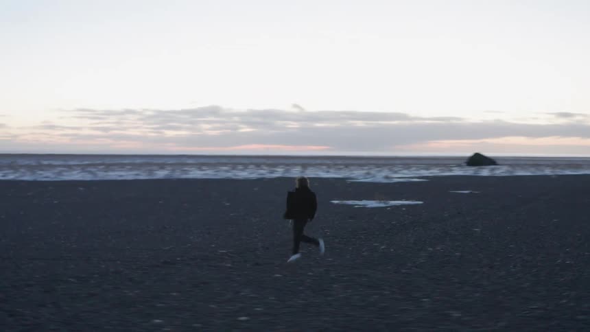 Man runs along the coast at dusk