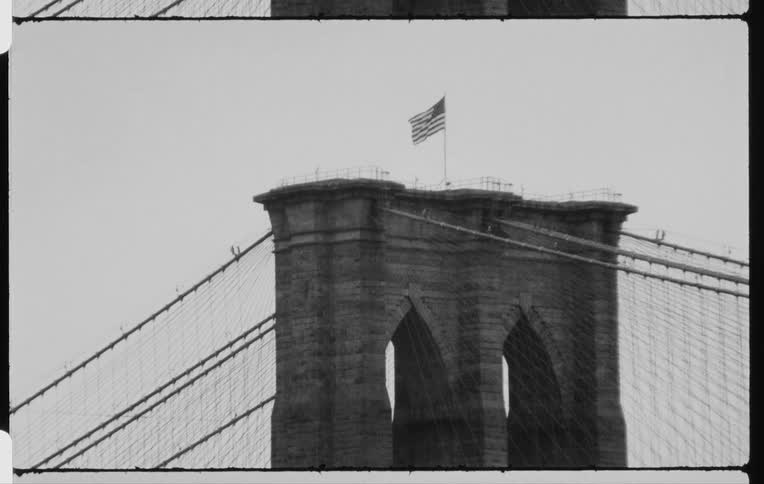 A flag on top of a bridge