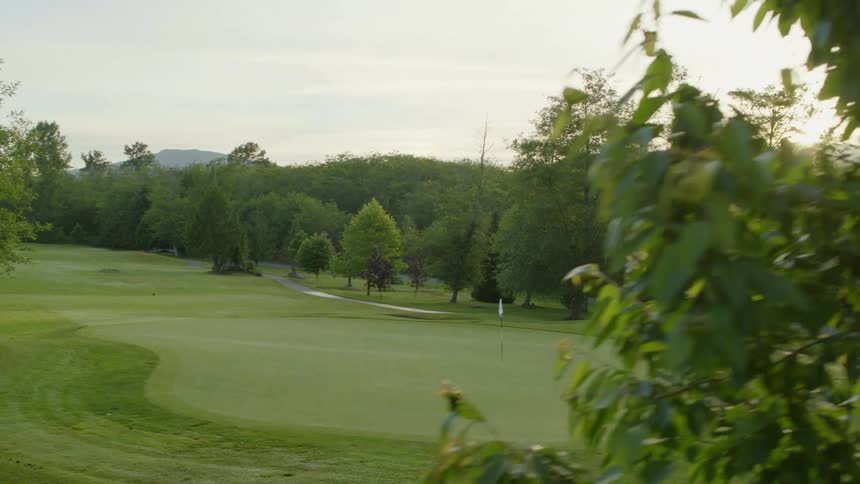 Aerial view of a golf course at sunrise