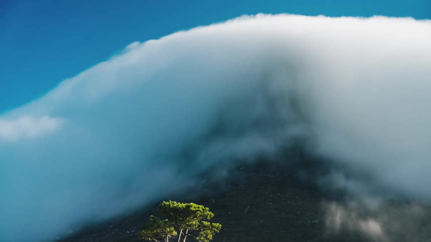 Time lapse of clouds moving over a cliff