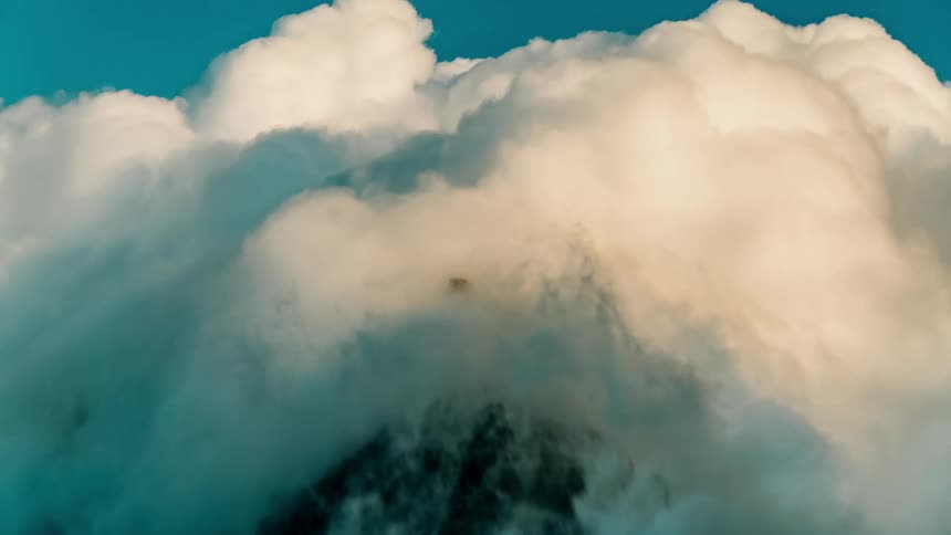 Time lapse of clouds covering a mountain