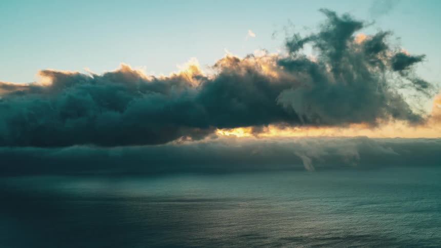 Timelapse of clouds over the ocean at sunset
