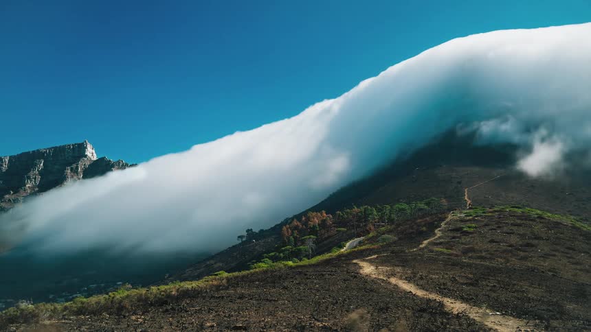 Time lapse of clouds moving over a hill