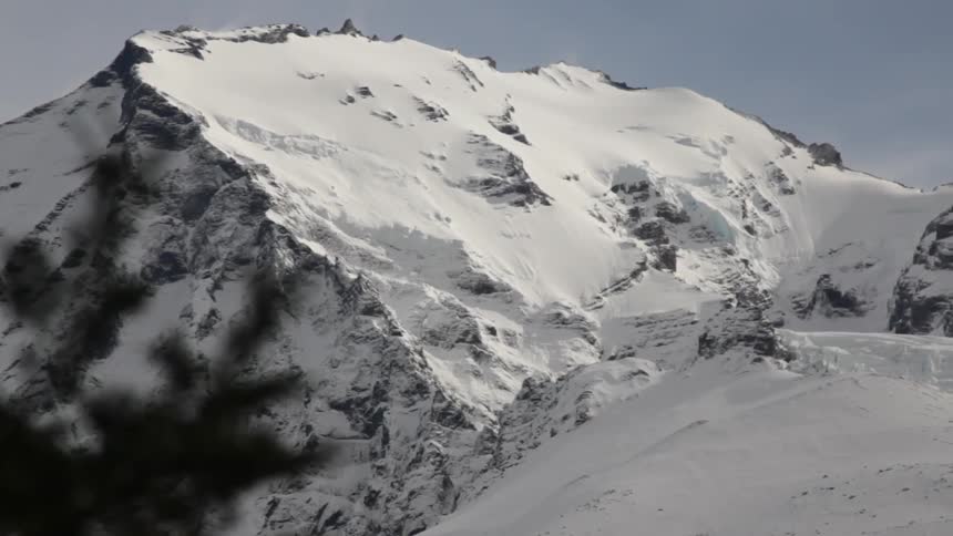 A snow covered mountain in the daytime
